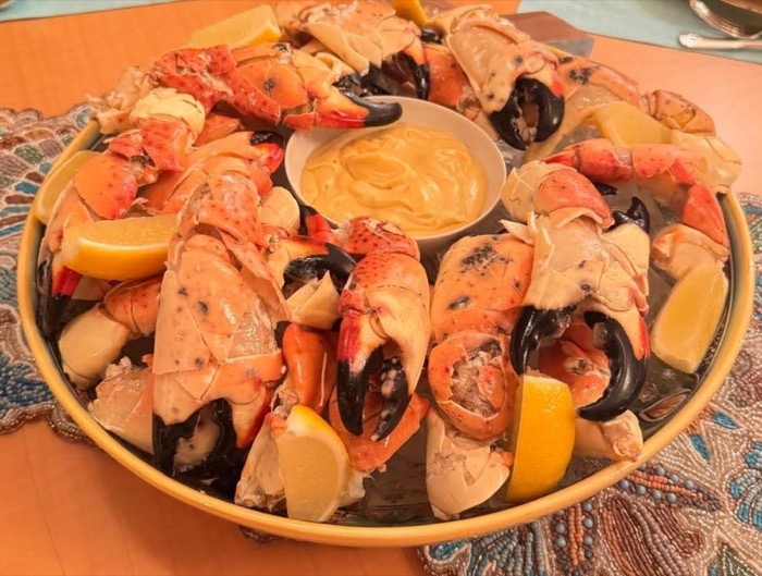Platter of stone crab claws with mustard sauce and lemon