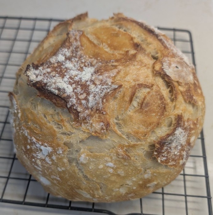Rustic sourdough loaf on a cooling rack