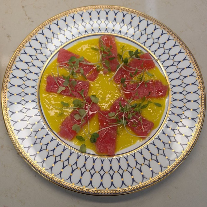 Tuna carpaccio with microgreens on a citrus dressing