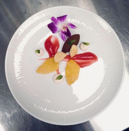 Citrus and chocolate dessert with an orchid